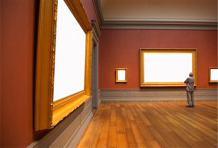 Rear view of man standing in art gallery, looking at empty gilded frame. Stock Photo - Premium Royalty-Free, Code: 6118-09144891