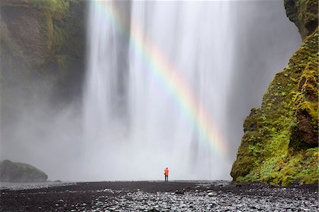 simsearch:6118-09028042,k - Rear view of person standing at foot of waterfall, moss-covered rocks and waterfall. Photographie de stock - Premium Libres de Droits, Code: 6118-09144839