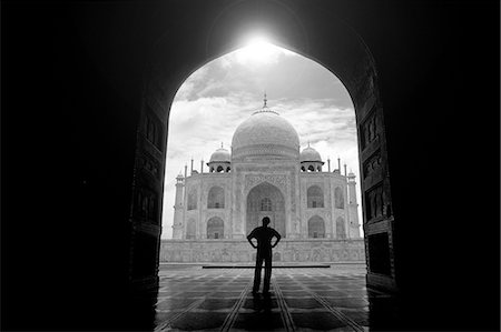 Rear view of man standing in archway near the Taj Mahal, Agra, India. Stock Photo - Premium Royalty-Free, Code: 6118-09144947