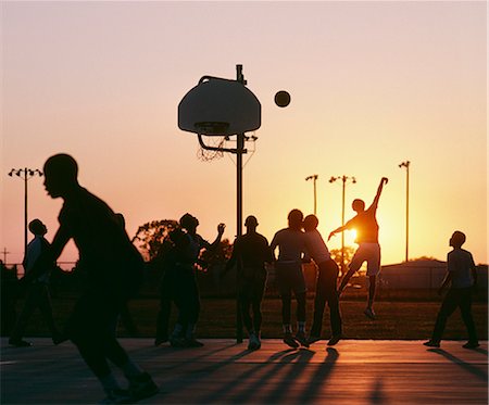 simsearch:6118-09027946,k - Silhouette of group of men playing basketball at sunset. Stock Photo - Premium Royalty-Free, Code: 6118-09144958