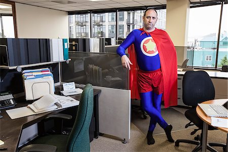 simsearch:6118-09147986,k - Caucasian middle aged man super hero in his cubicle office. Fotografie stock - Premium Royalty-Free, Codice: 6118-09147987