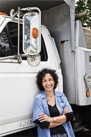 Hispanic woman truck driver and company delivery truck. Stock Photo - Premium Royalty-Free, Code: 6118-09148079