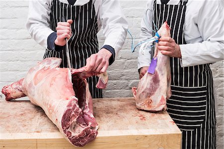 simsearch:6118-08729219,k - Two butchers working on butchering a lamb carcass for sale. Foto de stock - Sin royalties Premium, Código: 6118-09165872
