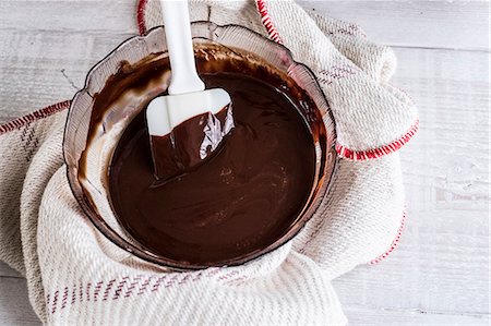 point of view dessert - A bowl of chocolate brownie ingredients being stirred by a spatula. Stock Photo - Premium Royalty-Free, Code: 6118-09166077