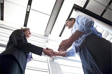 simsearch:6118-09173926,k - Businessman and woman meeting in the lobby of a conference centre. Stock Photo - Premium Royalty-Free, Code: 6118-09173569