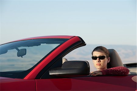 A young Caucasian woman in a convertible sports car. Stock Photo - Premium Royalty-Free, Code: 6118-09173654