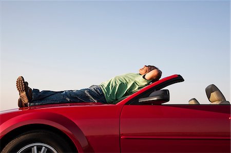 simsearch:6118-08488428,k - A senior male relaxing on the hood of his convertible sport car. Stock Photo - Premium Royalty-Free, Code: 6118-09173696