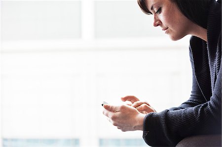 simsearch:6118-09173926,k - A Caucasian businesswoman working on a cell phone. Stock Photo - Premium Royalty-Free, Code: 6118-09173907