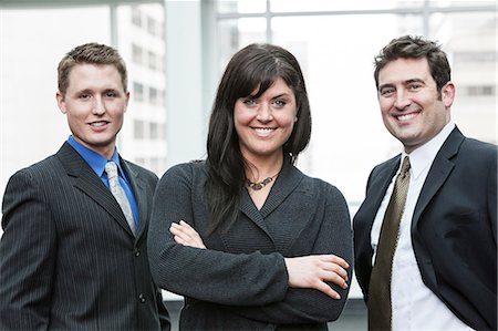 simsearch:6118-09173926,k - A group portrait of three business people, with a Caucasian woman as the lead. Stock Photo - Premium Royalty-Free, Code: 6118-09173934