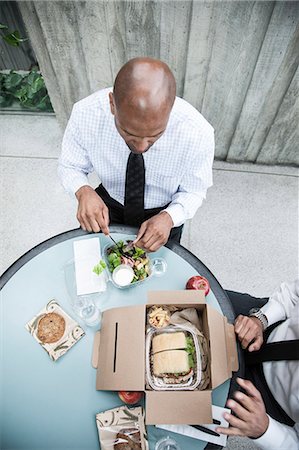 simsearch:6118-09173924,k - Looking down on a black businessman having lunch with a business associate. Stockbilder - Premium RF Lizenzfrei, Bildnummer: 6118-09174066