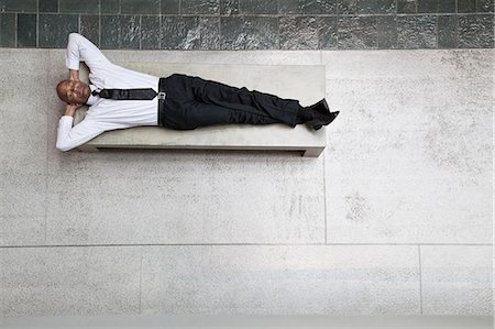 simsearch:6118-09173924,k - A view looking down on a businessman taking a break laying down on a bench. Stockbilder - Premium RF Lizenzfrei, Bildnummer: 6118-09174085