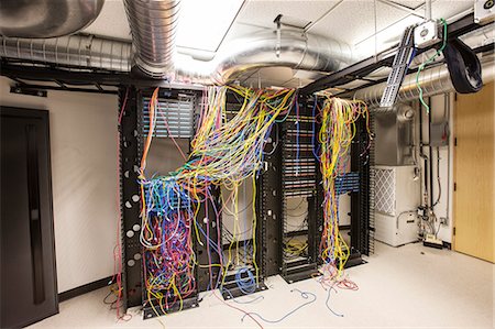 simsearch:400-07167932,k - A mess of Cat 5 cables in an office server room. Foto de stock - Sin royalties Premium, Código: 6118-09174279