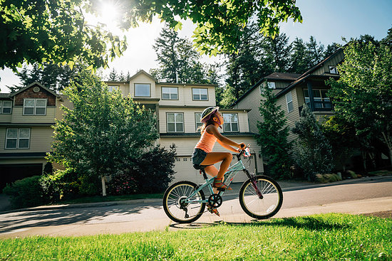 Tween Girl Biking on Sidewalk in Residential Neighborhood Stock Photo - Premium Royalty-Free, Image code: 6118-09183230