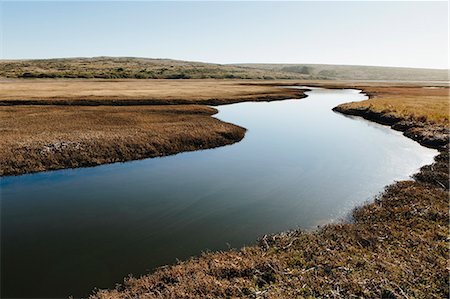 The open spaces of marshland and water channels. Flat calm water. Stock Photo - Premium Royalty-Free, Code: 6118-09112087