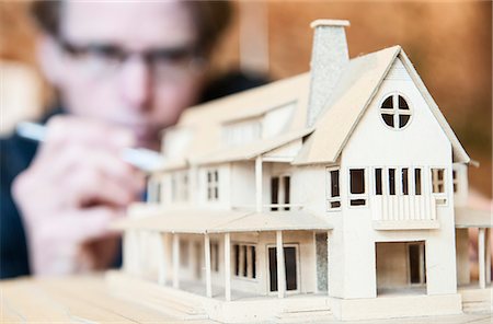 simsearch:6118-09059818,k - Caucasian male architect working on a scale model of a new home. Stock Photo - Premium Royalty-Free, Code: 6118-09129480