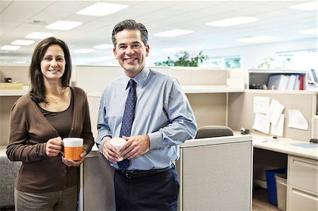 simsearch:6118-09129966,k - Caucasian man and woman executives in cubicle area of new office space Stock Photo - Premium Royalty-Free, Code: 6118-09129496