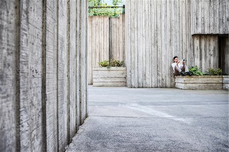 Businessman taking a break in a city park alcove. Stock Photo - Premium Royalty-Free, Code: 6118-09129578