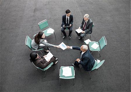 Mixed race group of business people in an informal team building meeting. Stock Photo - Premium Royalty-Free, Code: 6118-09129584