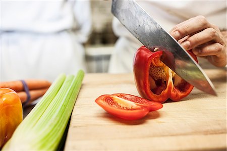 simsearch:6118-09079597,k - Close-up of a chef using a knife to chop vegetables. Stock Photo - Premium Royalty-Free, Code: 6118-09129742