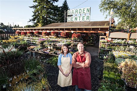 Caucasian man and woman garden centre nursery owners. Stock Photo - Premium Royalty-Free, Code: 6118-09129783