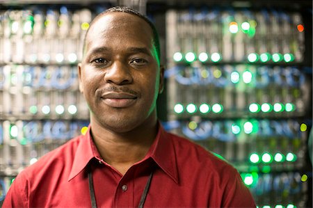 simsearch:6118-09129858,k - Black man technician in a computer server farm. Foto de stock - Sin royalties Premium, Código: 6118-09129856