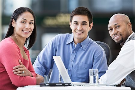 simsearch:6118-08066748,k - Mixed race team of business people at a table in a business centre. Stock Photo - Premium Royalty-Free, Code: 6118-09129896