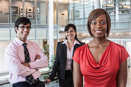 simsearch:6118-09129966,k - Mixed race team of business people in the lobby of a large office building. Stock Photo - Premium Royalty-Free, Code: 6118-09129965