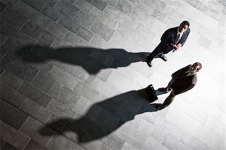 simsearch:6118-09129966,k - View from above of two businessmen and shadows on the floor of a business lobby. Stock Photo - Premium Royalty-Free, Code: 6118-09129966