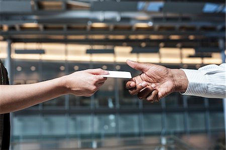 pictures of man lying on money - Closeup of  hands and a credit card transaction taking place. Stock Photo - Premium Royalty-Free, Code: 6118-09129970