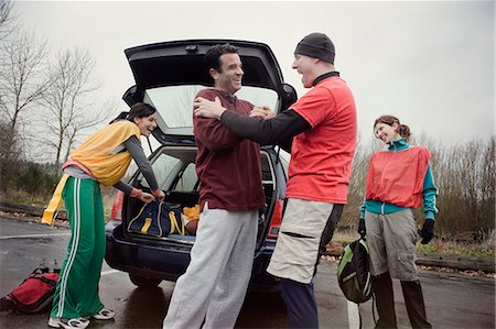 simsearch:6118-08023790,k - Group of friends unloading gear from a car prior to an American Flag Football game. Stock Photo - Premium Royalty-Free, Code: 6118-09130035