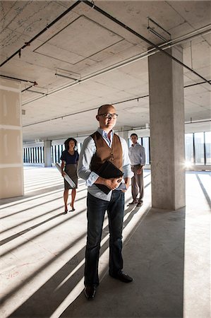 simsearch:6118-09129966,k - Portrait of a mixed race team of business people in a new empty office space. Stock Photo - Premium Royalty-Free, Code: 6118-09139443