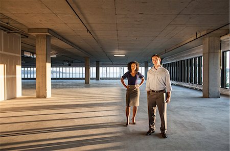 futuristic offices - Mixed race team of business people in a large empty raw office space. Stock Photo - Premium Royalty-Free, Code: 6118-09139448