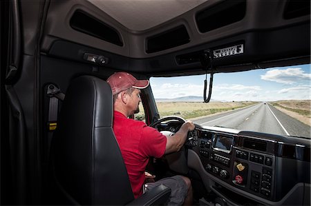 Interior cab view of a Caucasian man driving his  commercial truck. Stock Photo - Premium Royalty-Free, Code: 6118-09139473