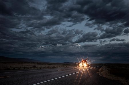 sunset road drive truck - Headlights of a commercial truck on a highway late in the day. Stock Photo - Premium Royalty-Free, Code: 6118-09139492