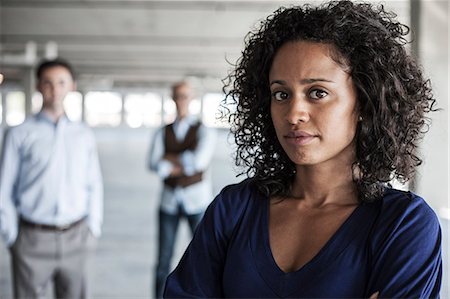 simsearch:6118-09139404,k - Portrait of a mixed race team of business people in a new empty office space. Photographie de stock - Premium Libres de Droits, Code: 6118-09139433