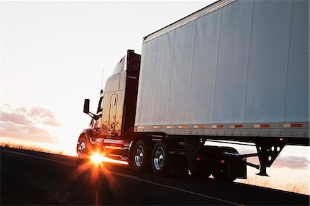 simsearch:632-08545840,k - Silhouette of a  commercial truck driving on a highway at sunset. Stock Photo - Premium Royalty-Free, Code: 6118-09139519