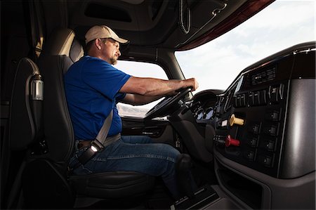 simsearch:6118-09139539,k - Caucasian man driver in the cab of a  commercial truck. Stock Photo - Premium Royalty-Free, Code: 6118-09139538