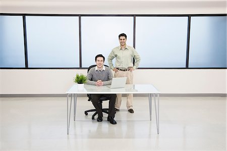 Team of two Caucasian businessmen in a computer server farm office. Stock Photo - Premium Royalty-Free, Code: 6118-09139640