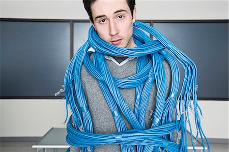 simsearch:6118-09129485,k - Caucasian businessman wrapped up in CAT 5 computer cables from a computer server farm. Foto de stock - Sin royalties Premium, Código: 6118-09139646