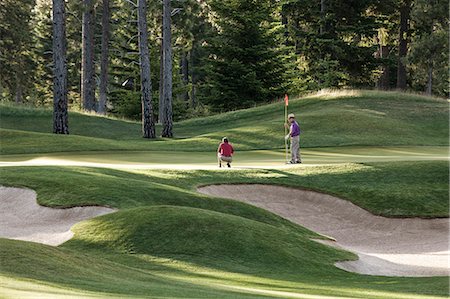 simsearch:6118-09144991,k - Senior golfers on one of the greens of the golf course. Stock Photo - Premium Royalty-Free, Code: 6118-09139688