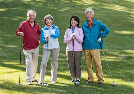 simsearch:832-03640492,k - Two young senior golfing couples on the course and ready to play. Fotografie stock - Premium Royalty-Free, Codice: 6118-09139774