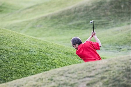 senior japanese golfer - Senior golfer hitting a second shot from the fairway of a golf course. Stock Photo - Premium Royalty-Free, Code: 6118-09139702