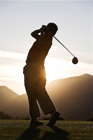 simsearch:6118-09144991,k - Senior golfer teeing off at sunset. Stock Photo - Premium Royalty-Free, Code: 6118-09139706