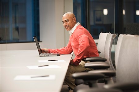 simsearch:6118-09139986,k - A black businessman working at a conference table at night. Foto de stock - Sin royalties Premium, Código: 6118-09139806