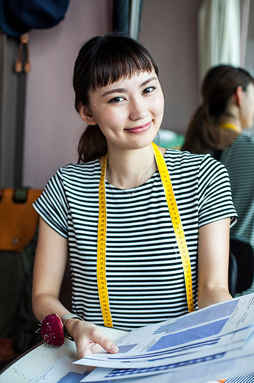 Japanese female fashion designer working in her studio, smiling at camera. Stock Photo - Premium Royalty-Free, Image code: 6118-09200159