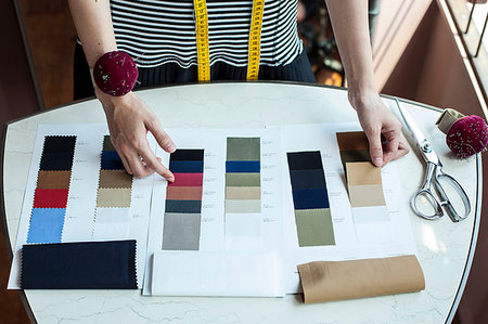 fashion designer table close - High angle close up of fashion designer working in her studio, looking at fabric samples. Stock Photo - Premium Royalty-Free, Code: 6118-09200168