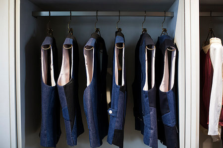 Close up of blue waistcoats hanging on a rail in clothing store. Stock Photo - Premium Royalty-Free, Code: 6118-09200183