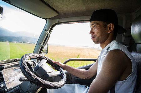 farmer with hat tractor and field - Portrait of Japanese farmer sitting in his tractor. Stock Photo - Premium Royalty-Free, Code: 6118-09200137