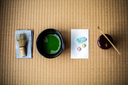 Tea ceremony utensils including bowl of green Matcha tea, a bamboo whisk and Wagashi sweets. Stock Photo - Premium Royalty-Free, Code: 6118-09200292