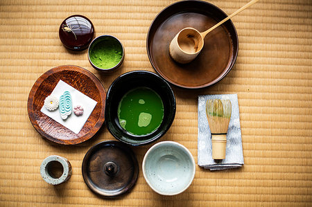 Tea ceremony utensils including bowl of green Matcha tea, a bamboo whisk and Wagashi sweets. Stock Photo - Premium Royalty-Free, Code: 6118-09200294